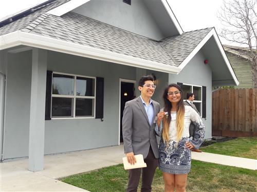 Kennedy High School Digital Arts teacher Mitzi Perez and her partner Anthony Caro in front of the newly purchased home. 