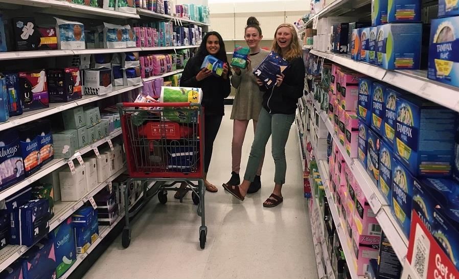 Genevieve Schweitzer with her friends buying tampons and pads for homeless shelter. 