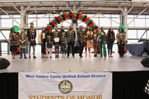 African American Students holding Academic Achievement Awards 